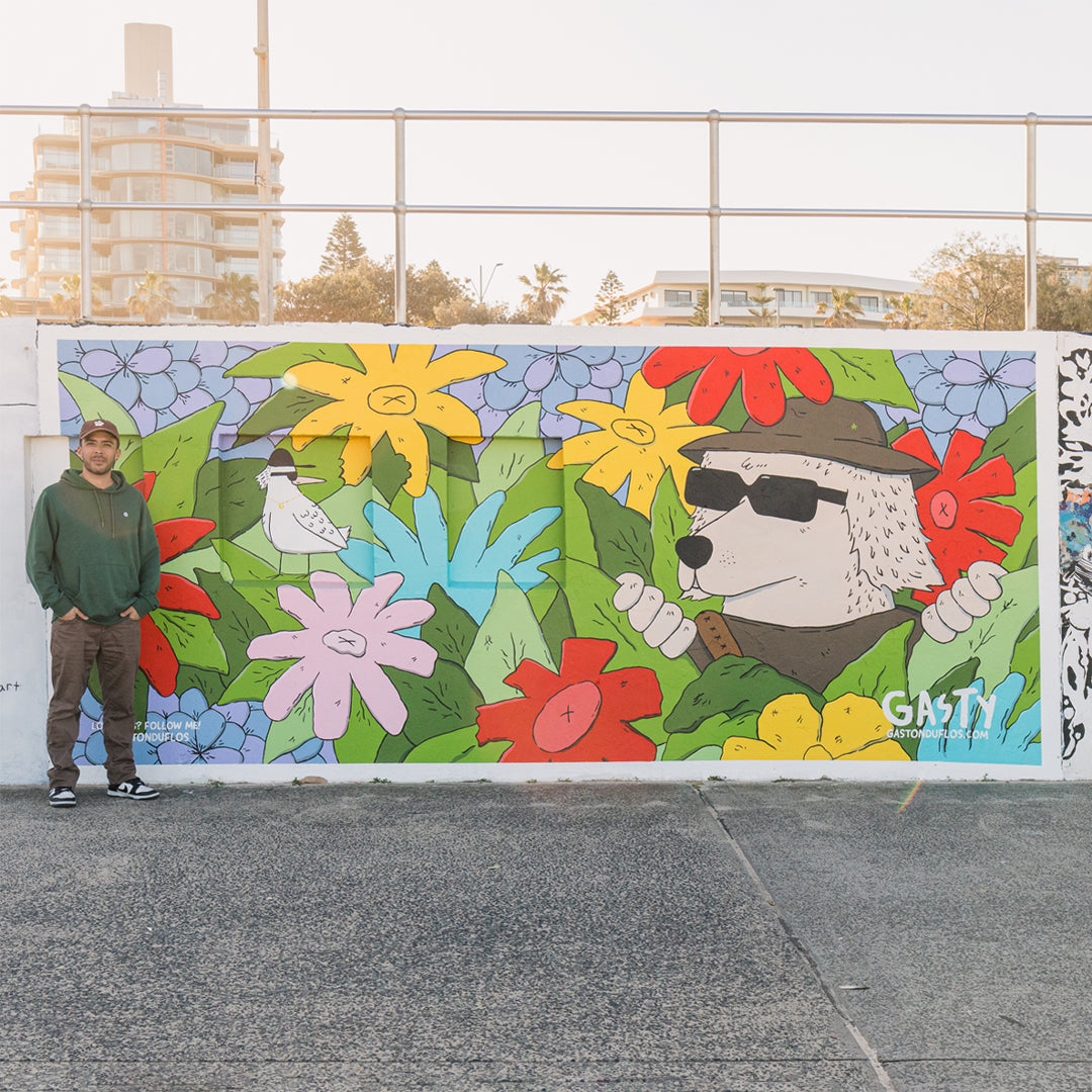 Gaston Duflos next to his mural art at Bondi Beach